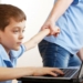 man dragging kid off computer
