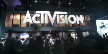 Attendees walk past Activision Blizzard Inc. signage during the E3 Electronic Entertainment Expo in Los Angeles, California, U.S., on Wednesday, June 14, 2017. Photographer: Patrick T. Fallon/Bloomberg
